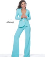 Model wearing Jovani 02637 turquoise ensemble with deep V-neck and jeweled buttons, another front view.