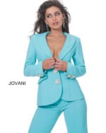 Model wearing Jovani 02637 turquoise ensemble with deep V-neck and jeweled buttons, alternate front view.