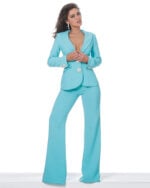 Model wearing Jovani 02637 turquoise ensemble with deep V-neck and jeweled buttons, front view.