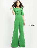 Model wearing Jovani 04284 emerald green jumpsuit with wide-leg pants and square neckline, front view.