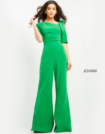 Model wearing Jovani 04284 emerald green jumpsuit with wide-leg pants and square neckline, front view.