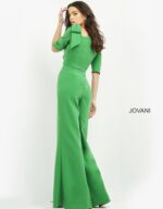 Model wearing Jovani 04284 emerald green jumpsuit with wide-leg pants, back view.