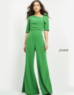 Model wearing Jovani 04284 emerald green jumpsuit with wide-leg pants and square neckline, front view.