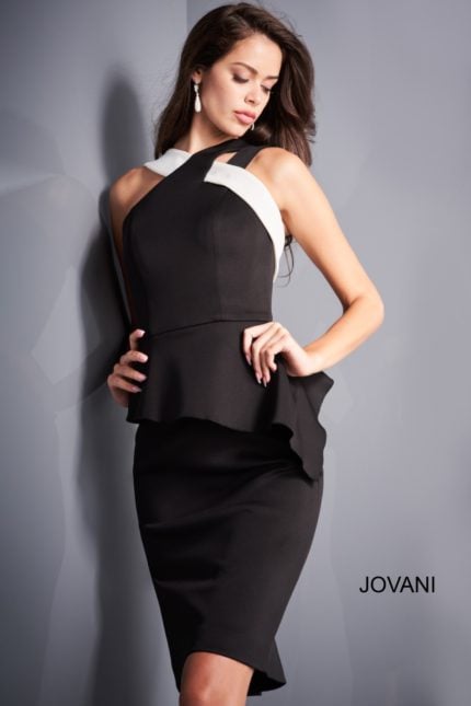 Model wearing Jovani 04409 black dress with peplum waist and asymmetrical neckline, front view