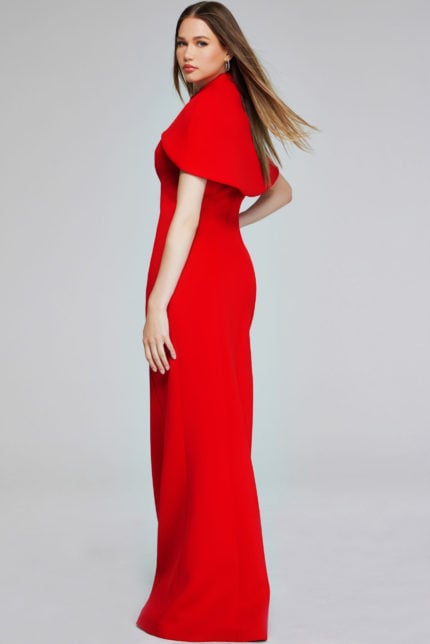 Back view of model wearing Jovani 06538 red dress with cape sleeves and sophisticated silhouette.