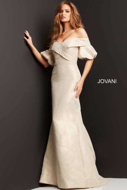 Model wearing Jovani 06831 beige dress, front view, off-the-shoulder neckline with puff sleeves.