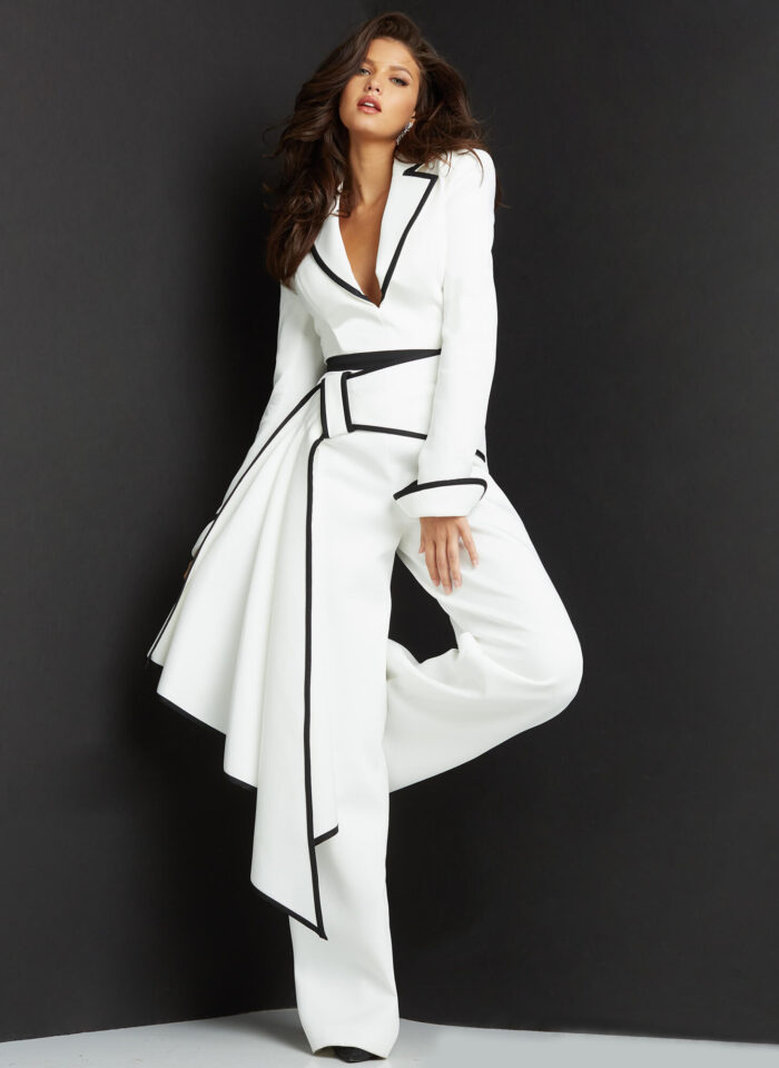 Model wearing Jovani 06917 White Black Long Sleeve Plunging Neck Jumpsuit
