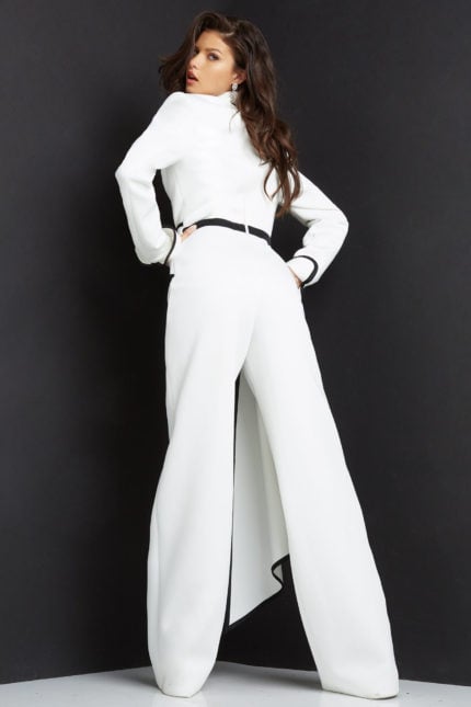 Model wearing Jovani 06917 white jumpsuit with black trim, back view.