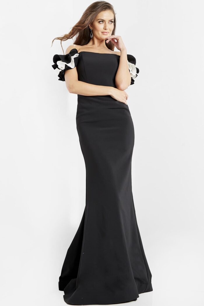 Model wearing Jovani 07017 Black and White Off the Shoulder Sheath Dress