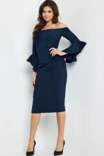 Model in Jovani 07066 navy midi dress with ruffled sleeves.