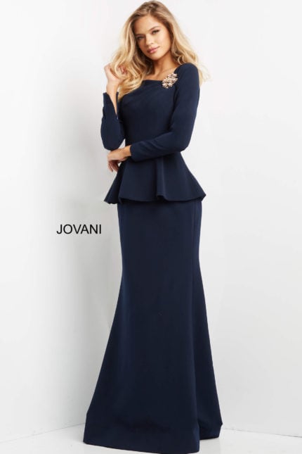 Model in Jovani 07131 navy dress showcasing long sleeves and embellishment detail.