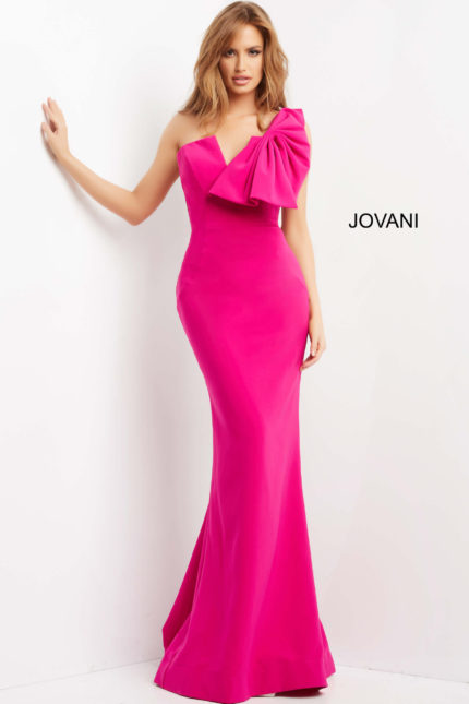 Model wearing Jovani 07306, fuchsia dress with asymmetric neckline and bow, front view.