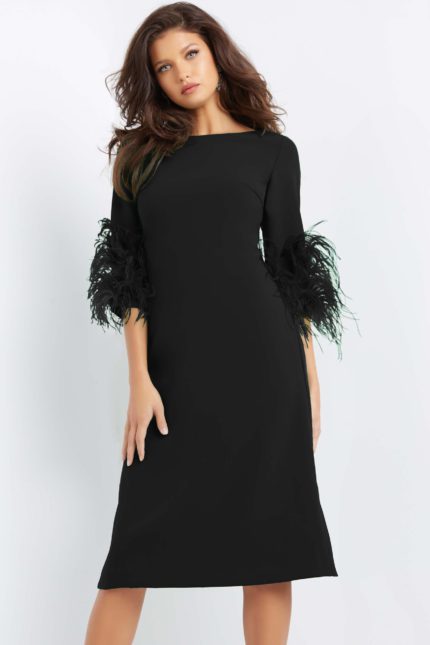 Model wearing Jovani 07341 black midi dress with feather-trimmed sleeves, front view.