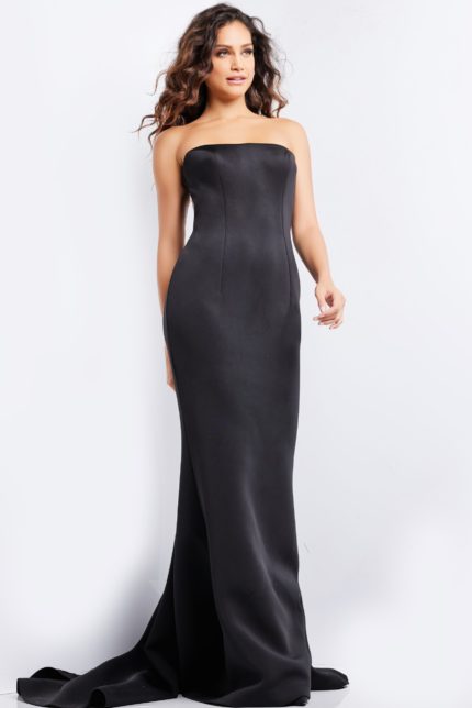 Model wearing Jovani 07427 elegant black gown with a strapless neckline and fitted silhouette.