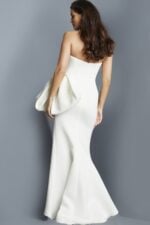 Model wearing Jovani 07581 white gown showing back view with dramatic side drape.