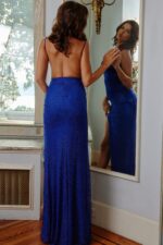 Back view of model wearing Jovani 08531 blue fitted gown with low back and high slit.