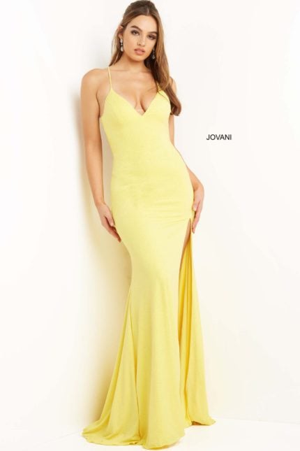 Model wearing Jovani 08153 yellow gown with V-neckline and thin straps.