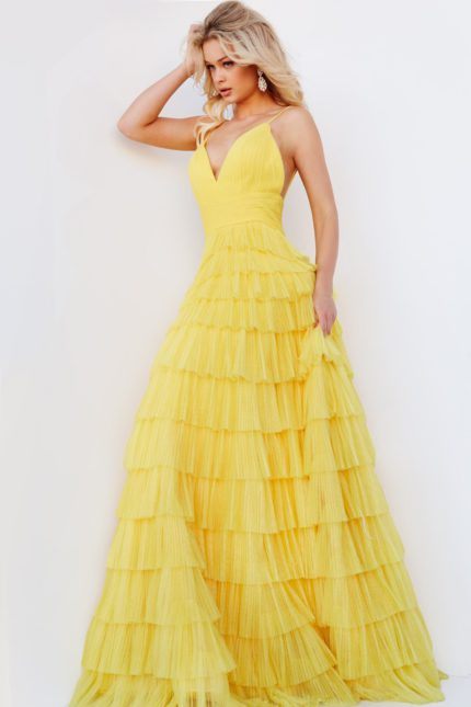 Model wearing Jovani 08480 yellow gown with deep neckline, side view.