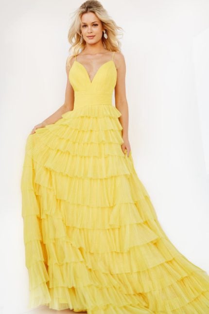 Model wearing Jovani 08480 yellow gown with cascading ruffle skirt, front view.