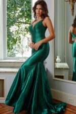 Model showing mermaid silhouette of Jovani 08157 green gown.