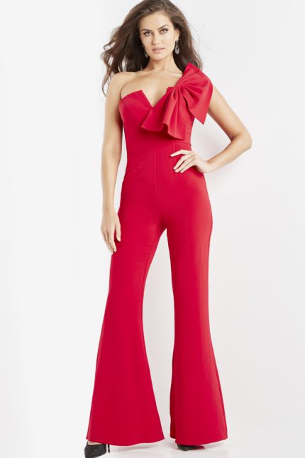 Model wearing Jovani 09525 red jumpsuit, front view with one-shoulder bow detail.