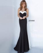 Model styled in Jovani 12020 black gown showcasing mermaid silhouette