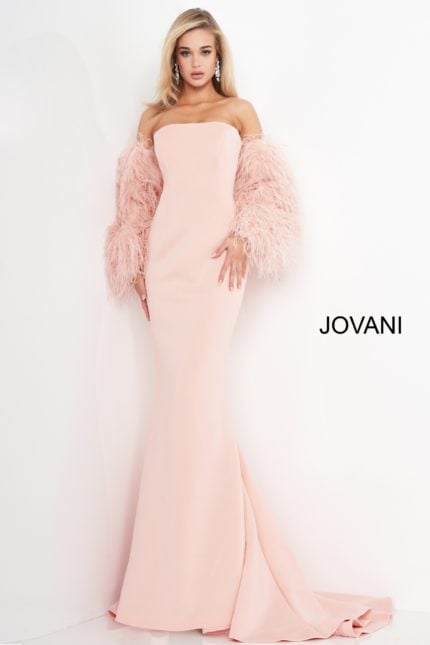 Model wearing Jovani 1226 blush mermaid gown with strapless neckline and feathered sleeves.