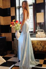 Model in Jovani 23010 showing front and side profile of blue gown.