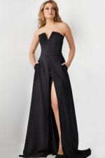 Model wearing Jovani 23150 black gown with plunging neckline and high slit.