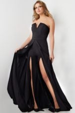 Model wearing Jovani 23150 black gown with sweetheart neckline and high slit.