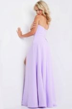 Model wearing Jovani 23150 lilac gown showing back view with flowing skirt.