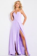 Model wearing Jovani 23150 lilac gown featuring a strapless design and high slit.