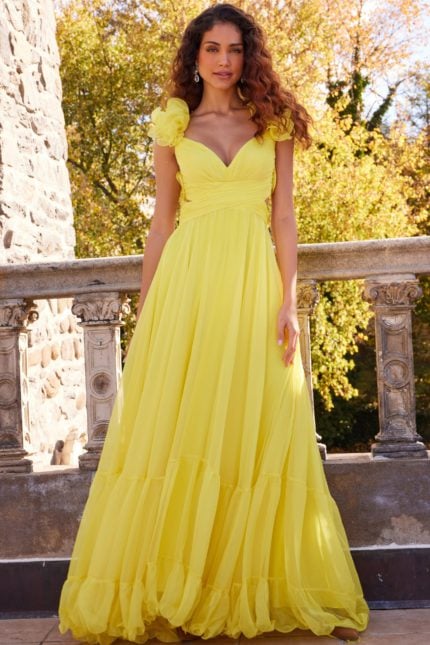 Model wearing Jovani 23322 yellow dress with floral appliqué and sweetheart neckline