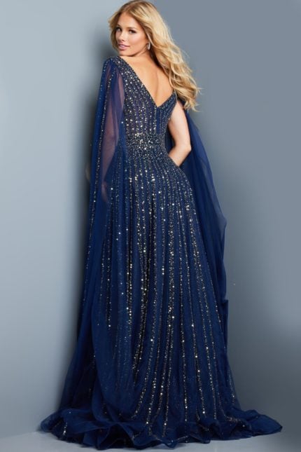 Model wearing Jovani 23362 navy dress with sequins and cape sleeve, back view.