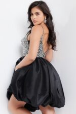 back view of model wearing 23561 black dress with bubble skirt