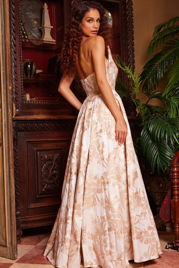 Model wearing Jovani 23625 Gold Print Pleated A Line Gown