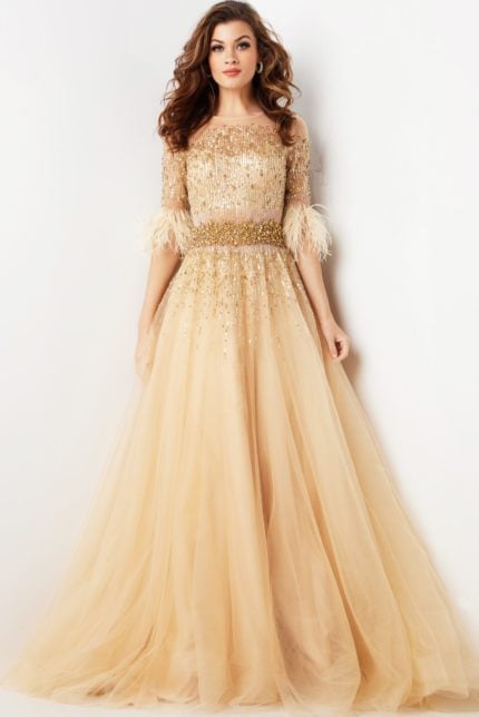 Model wearing Jovani 23629 elegant beige gown with sequined bodice and feathered sleeve details.