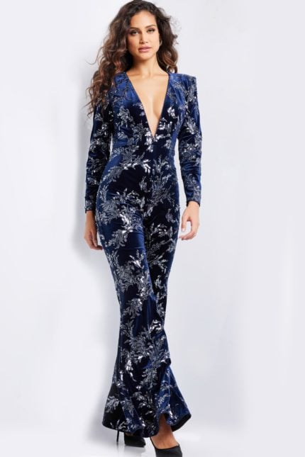 Model wearing Jovani 23708 navy jumpsuit showing front details and silver sequins.