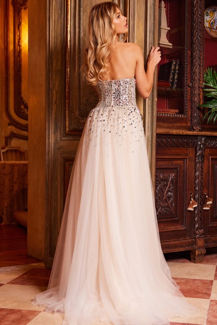 Model wearing Jovani 23712 Nude Silver Embellished Strapless Prom Gown