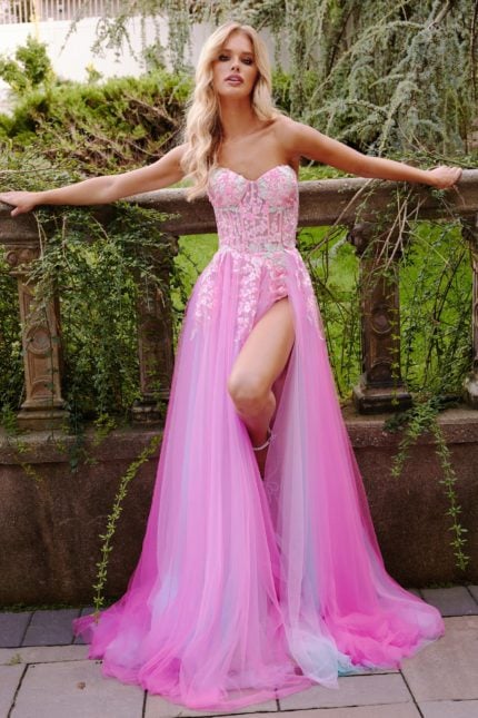 Model wearing Jovani 23713 pink gown with sweetheart neckline and flowing skirt.