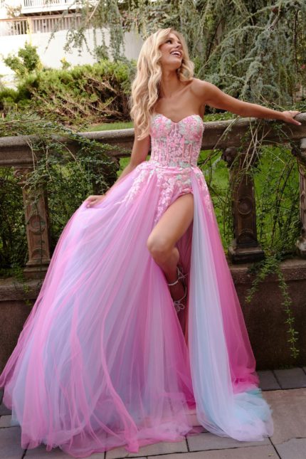 Model wearing Jovani 23713 pink gown with high slit and embroidered bodice.