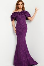 Model in Jovani 23847 purple gown, featuring dramatic ruffled neckline