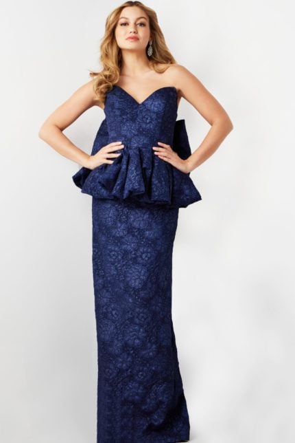 Model wearing Jovani 23849 navy gown with sweetheart neckline and peplum detail.