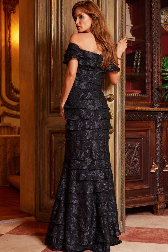 Model wearing Jovani 23890 Black Off the Shoulder Sheath Evening Dress