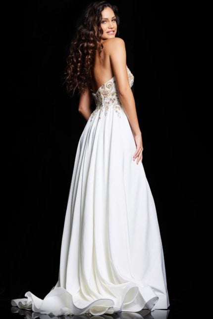 Model wearing Jovani 23937 white gown with embellished bodice, back view.