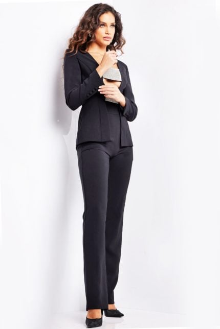 model wearing 24119 black jumpsuit showcasing front details with unique neckline