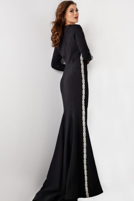 model wearing Jovani 24191: black mermaid gown with silver embellishment, back view