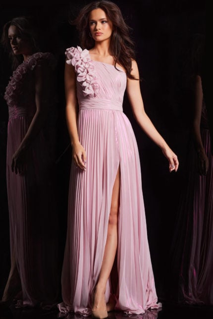 Model wearing Jovani 24609 pink dress with pleated skirt and floral shoulder embellishments.