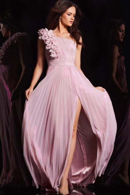 Model wearing Jovani 24609 pink dress showcasing detailed floral shoulder and high slit.