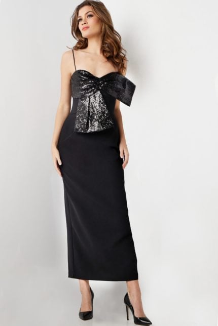 Model wearing Jovani 25745 elegant black dress with sequin bow detail and sweetheart neckline.